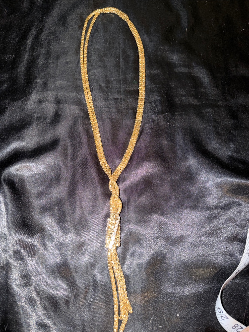 Gold Tone Knot Lariat Necklace. Crystal accents.